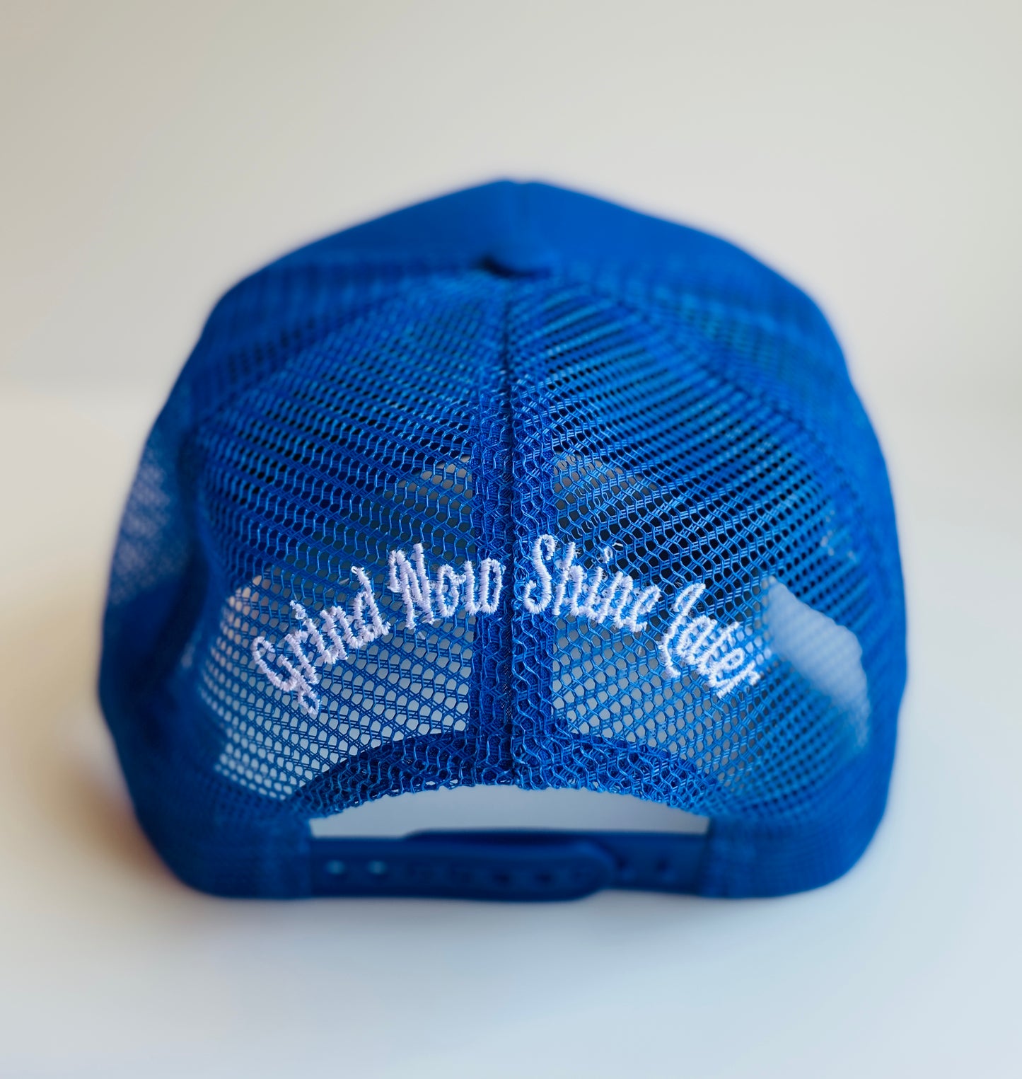 Grind now shine later trucker hat