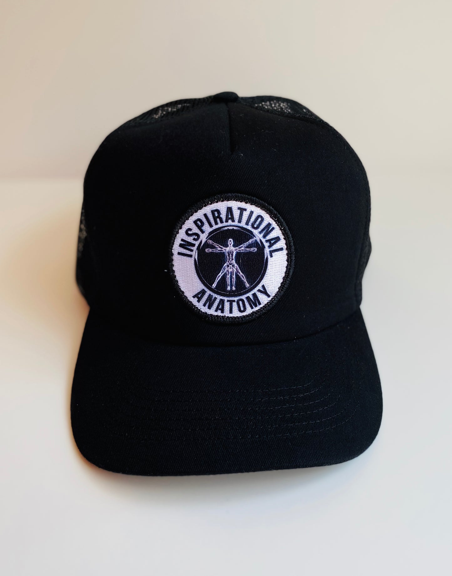 Black intelligence trucker hat