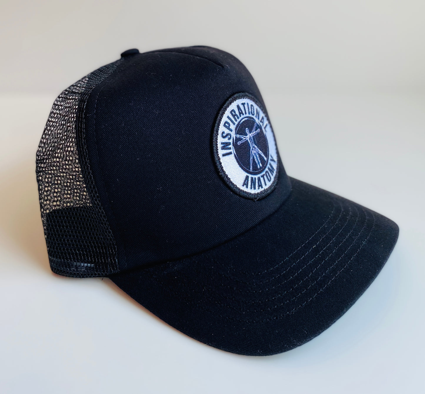 Black intelligence trucker hat